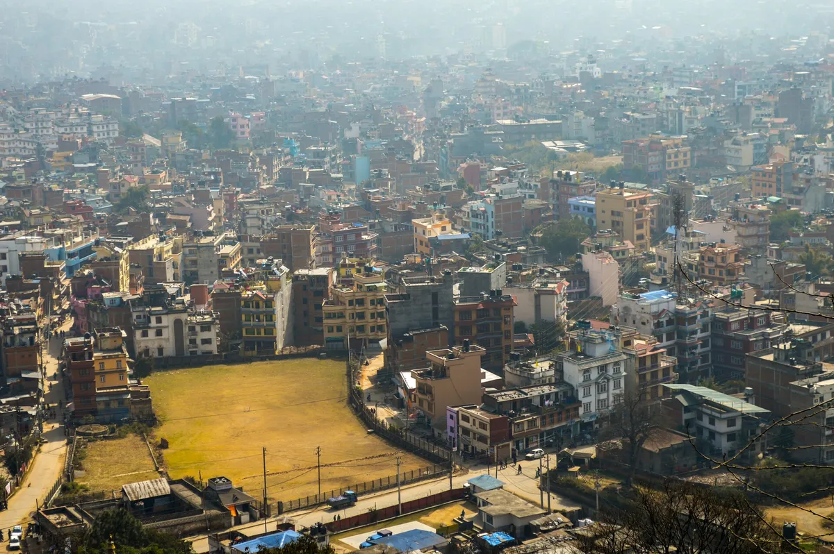 Kathmandu city seen from above with hills on the horizon